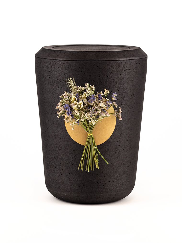 Biologisch abbaubare Urne in Anthrazit mit Blütenschmuck für die Naturbestattung